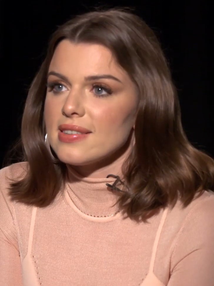 Julia Fox: Close-up portrait of a woman with shoulder-length brown hair wearing a pink turtleneck top during an interview